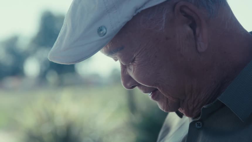 Portrait of an elderly man wearing a white beret outdoors