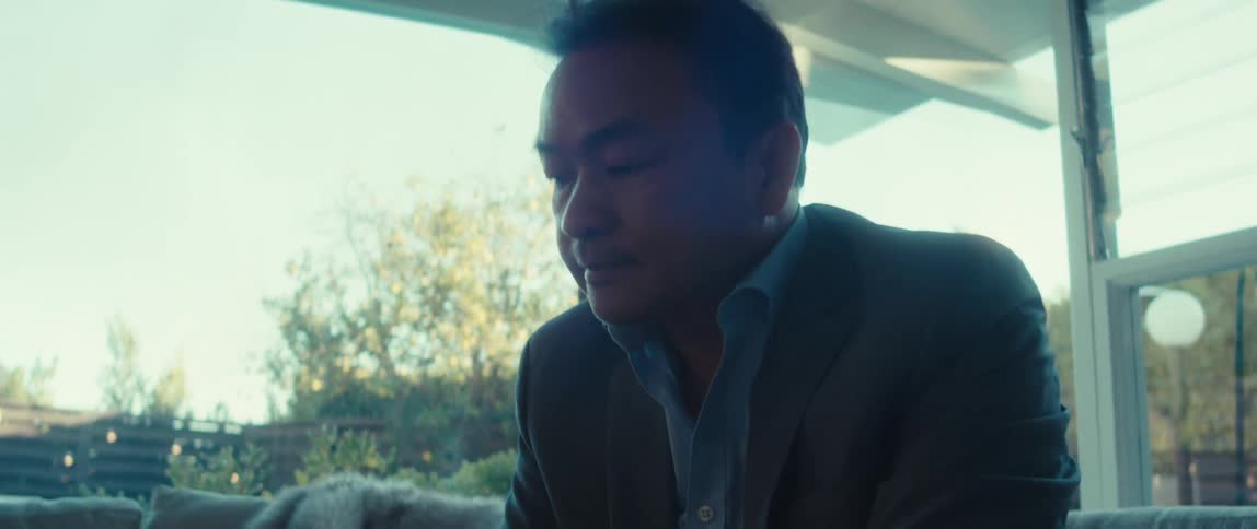 Man in blazer sitting working on a laptop