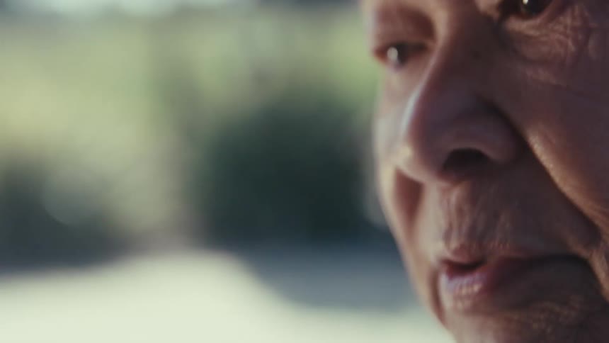 A close up shot shows the side profile of an older persons face highlighting their eye nose and wrinkled skin