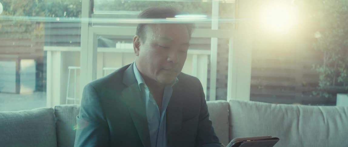 A man is using his tablet at home