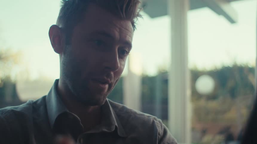 A man is talking on his cell phone and giving hand gestures
