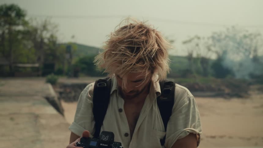 Outdoor photographer in a natural area using a professional camera
