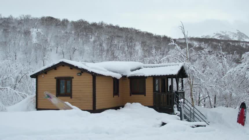 A cozy wooden cabin nestled amidst a snowcovered winter landscape perfect for a peaceful retreat