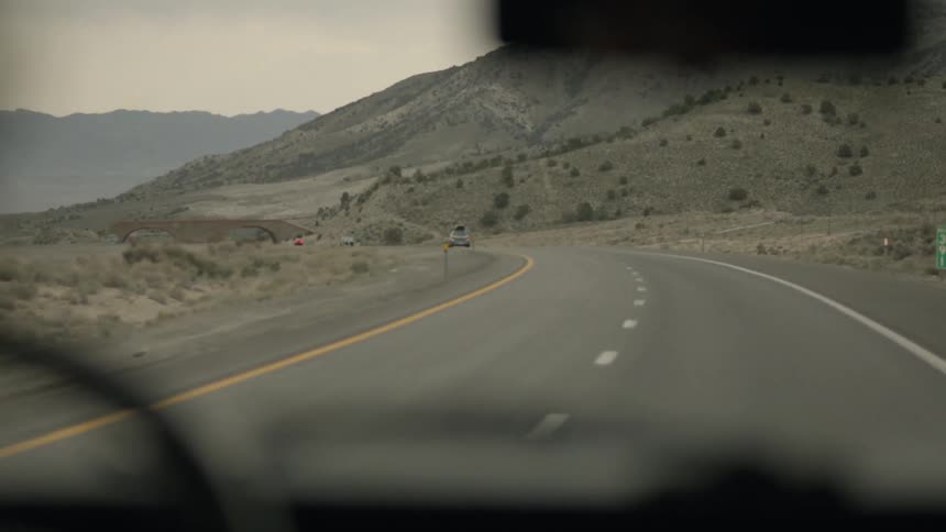 Cars drive on a rural road