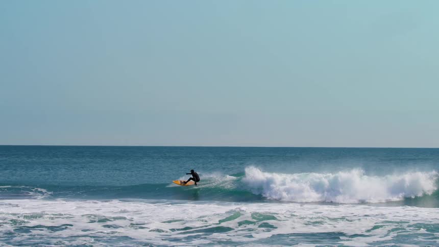 A surfer riding a powerful wave in the ocean