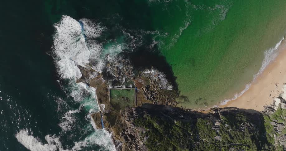 Aerial panorama of a rocky coastline by the greenish sea