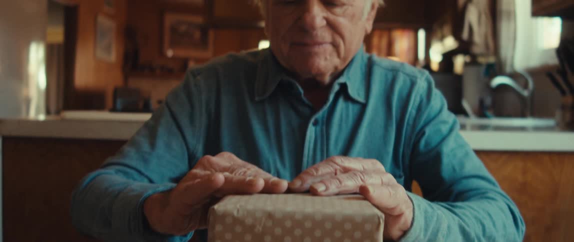 A man finishes wrapping a gift