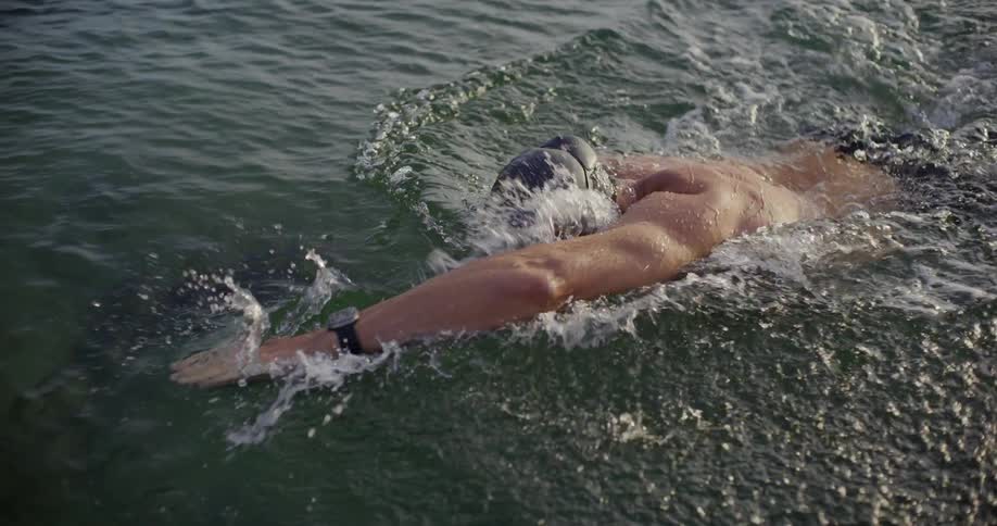 A man is swimming in the ocean