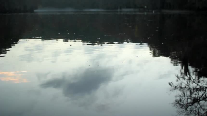 The water is calm reflecting the sky above