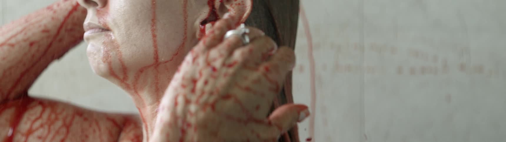 A woman showers in red water