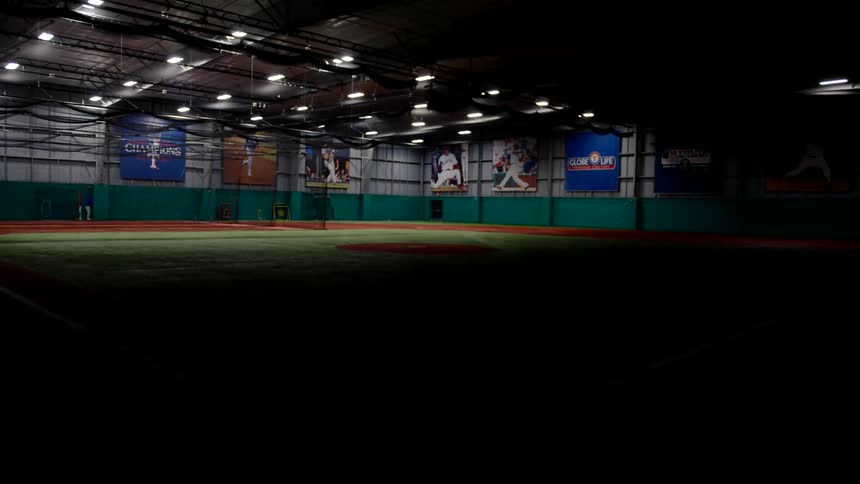 Lights turn on inside an indoor baseball stadium
