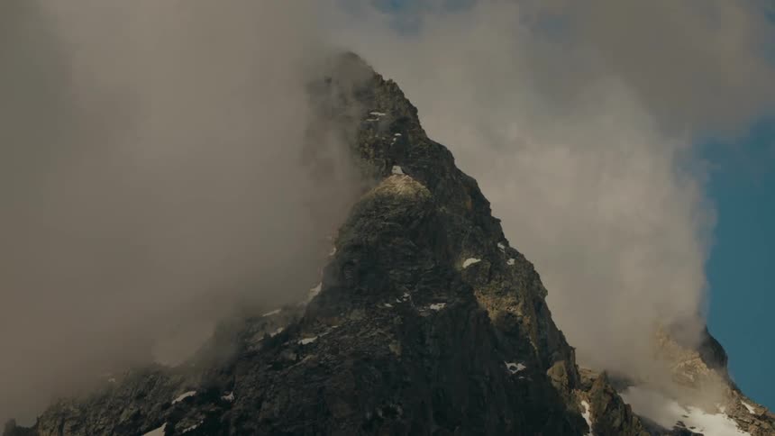 Mist and fog is surrounding the top of the mountain range