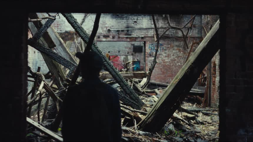 A man looks at the destruction of a building