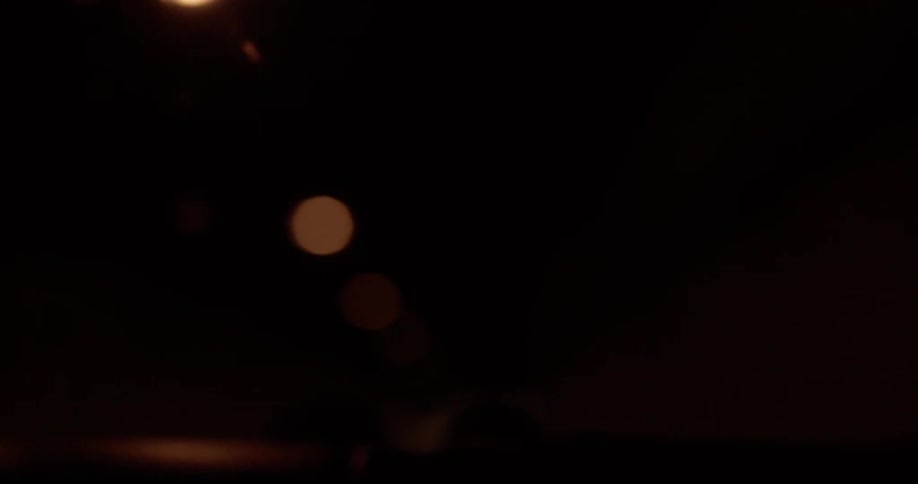 Blurred streetlights viewed from a moving vehicle at night