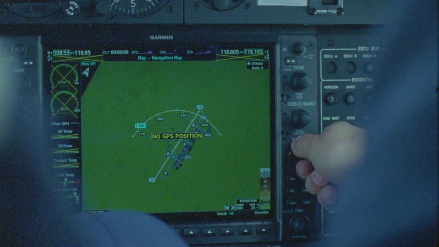 Hand interacting with an airplane cockpit showing a map