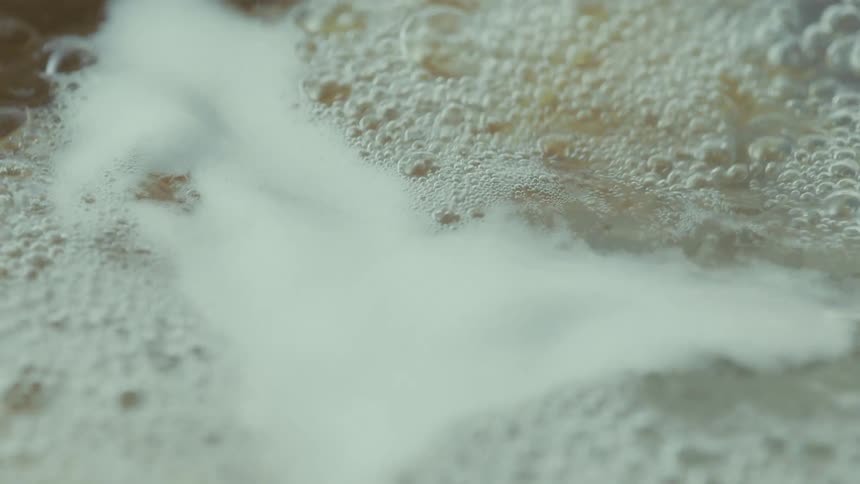 A frothy bubbling pool of dirty water in motion