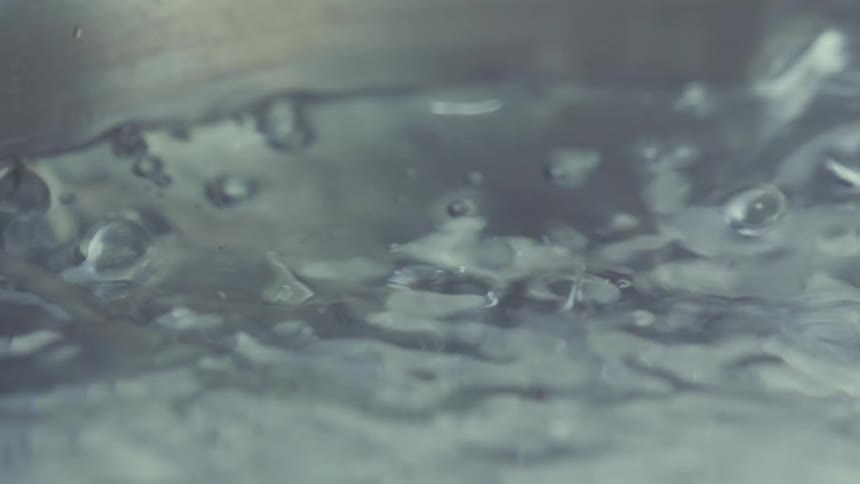 Water vigorously boiling in a pot