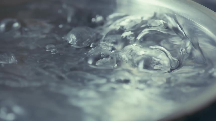 Water vigorously boiling in a pot