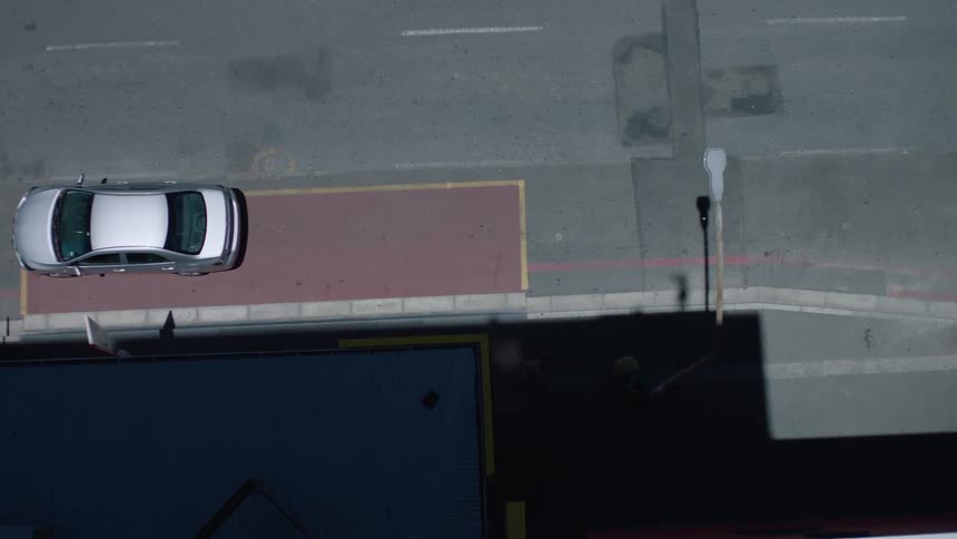 Top view of a silver car driving on a highway