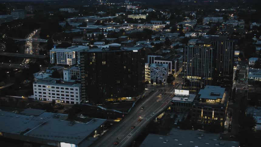 Aerial panorama at night of an illuminated city and vehicle traffic