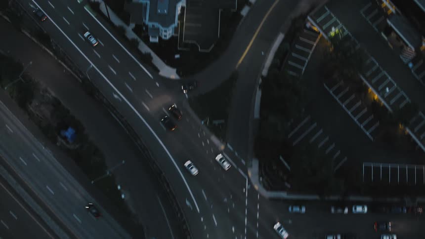 An aerial view of a busy highway interchange and city streets at night