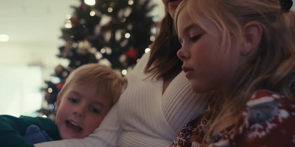 Mother reading a book to her two children