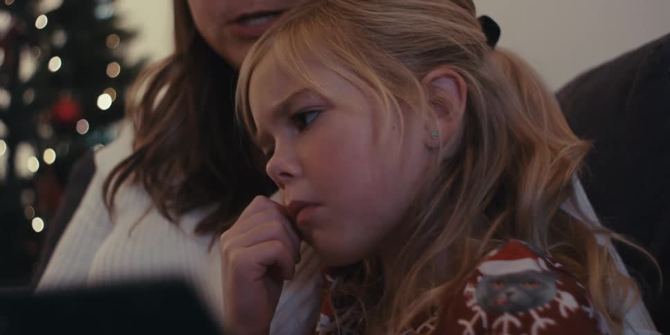 Mother and daughter sitting together reading a book