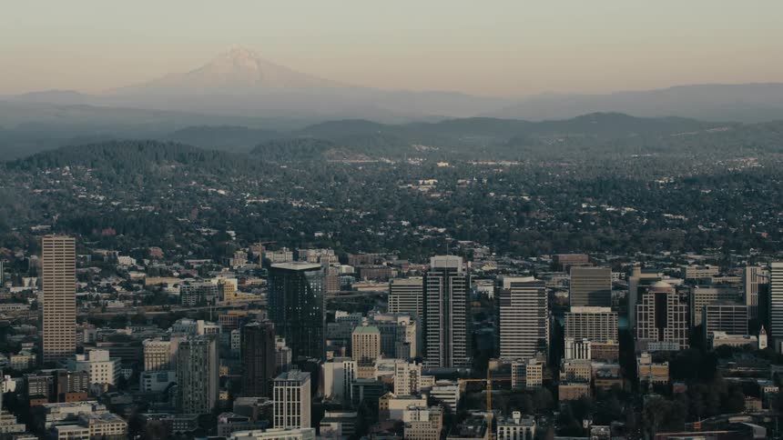 An aerial view of a metropolitan city with a block full of tall commercial buildings
