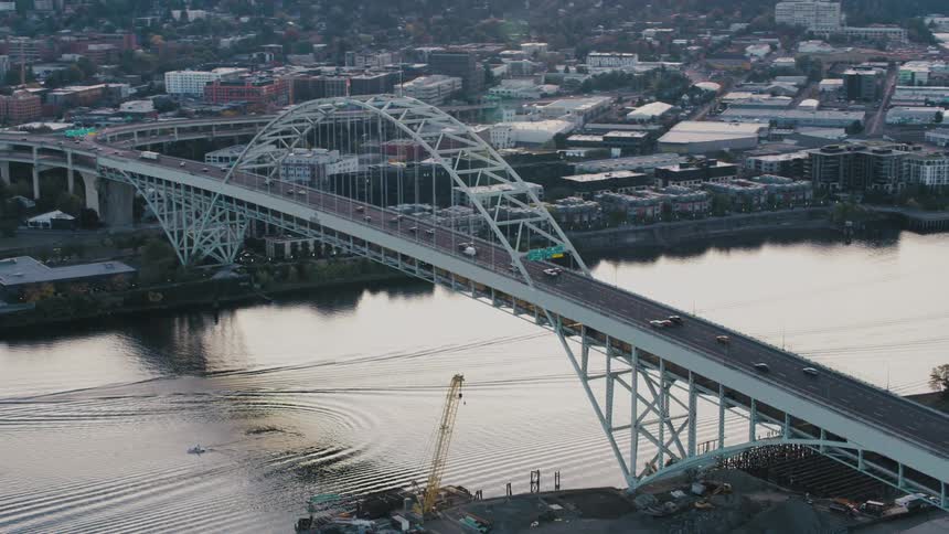 Aerial view of a bridge above a sea channel with vehicle traffic