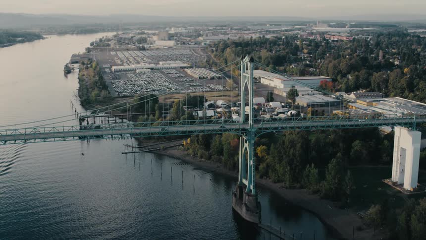 The iconic st johns bridge spans the willamette river in portland oregon connecting the citys east and west sides