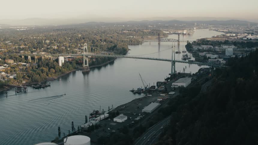 Several suspension bridges over a large body of water next to a large city