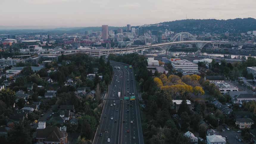 Aerial panorama of an urban city with highway and vehicle traffic