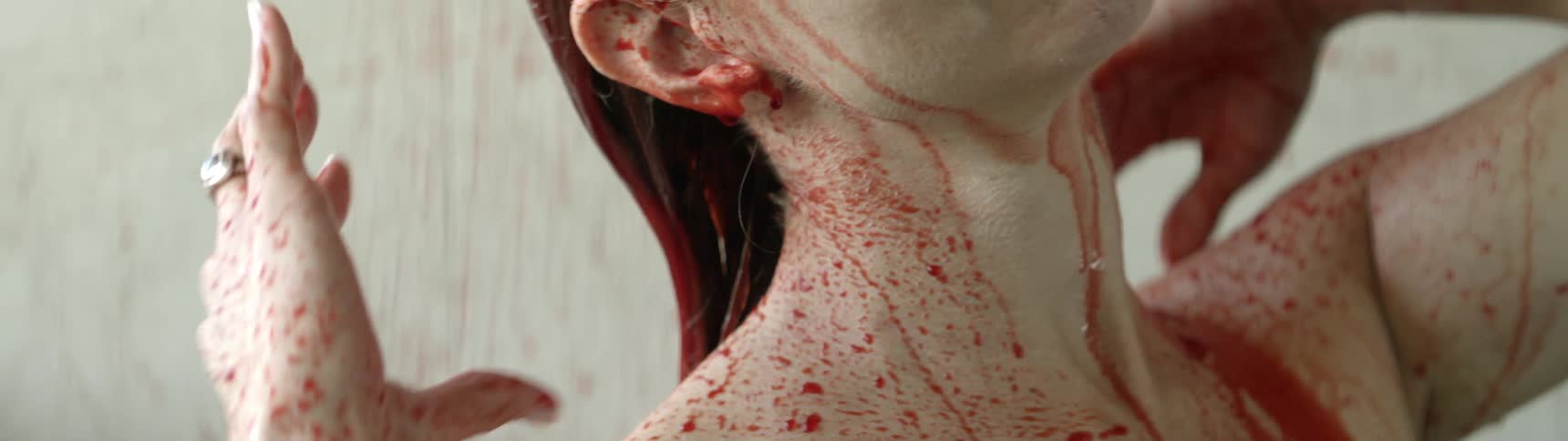 A woman washes blood off of her