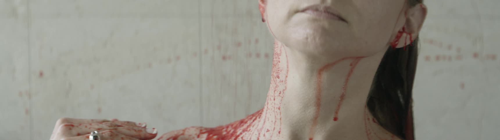 A woman washes blood off of her head