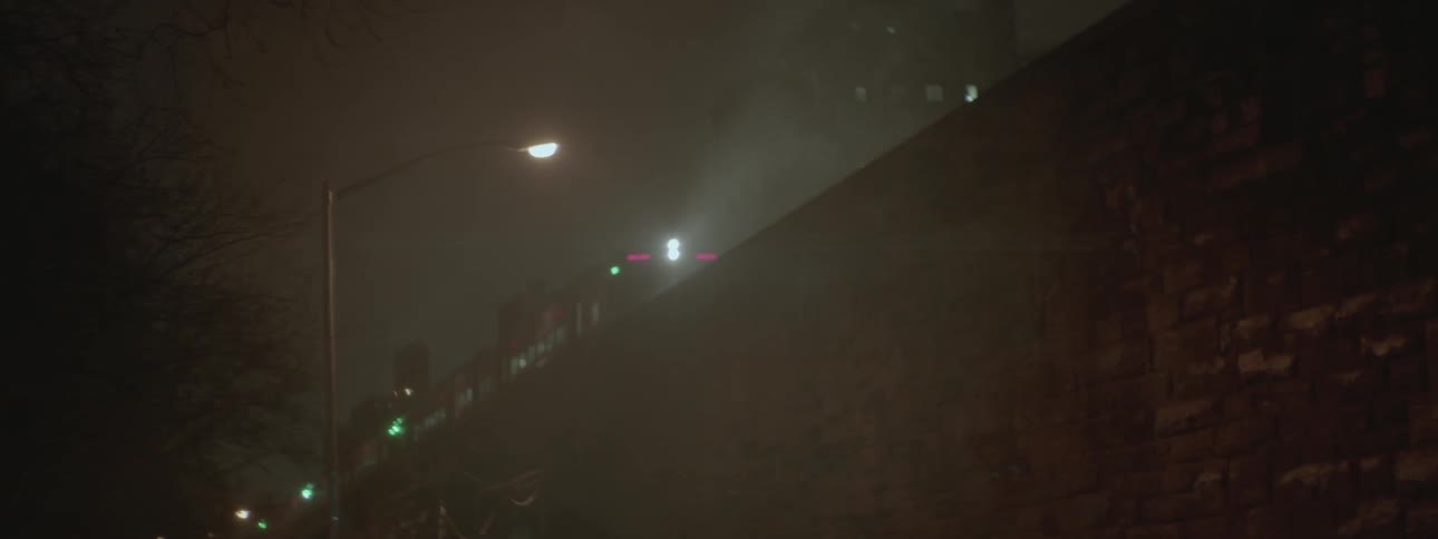 Train traveling through a city at night