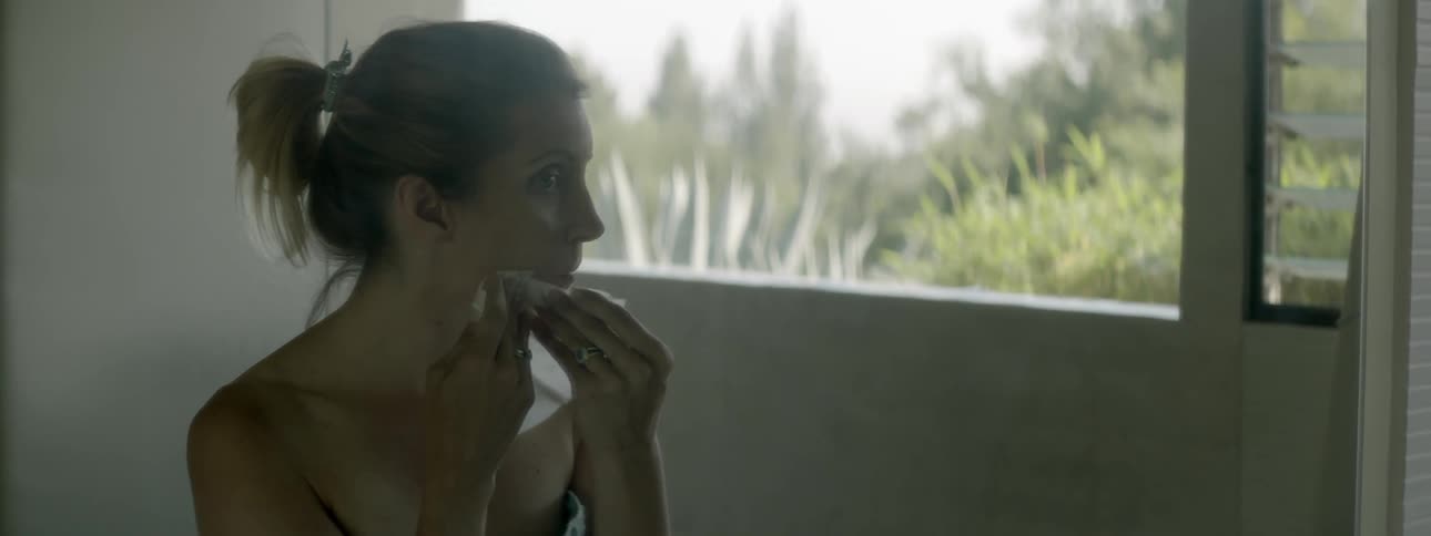 Woman wiping her face with a towelette