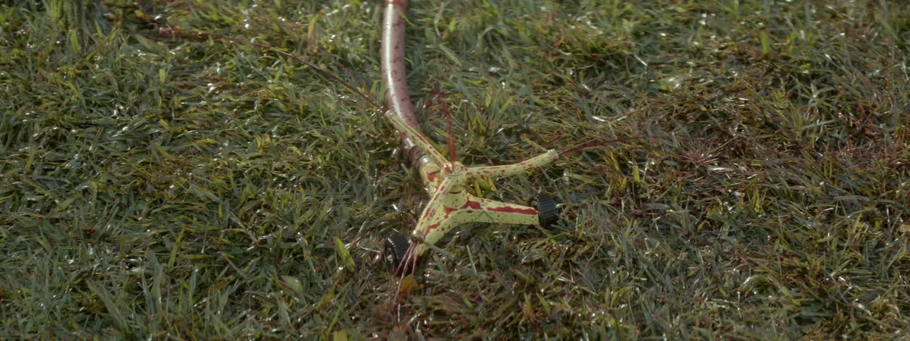 A sprinkler is squirting out a red blood-like liquid
