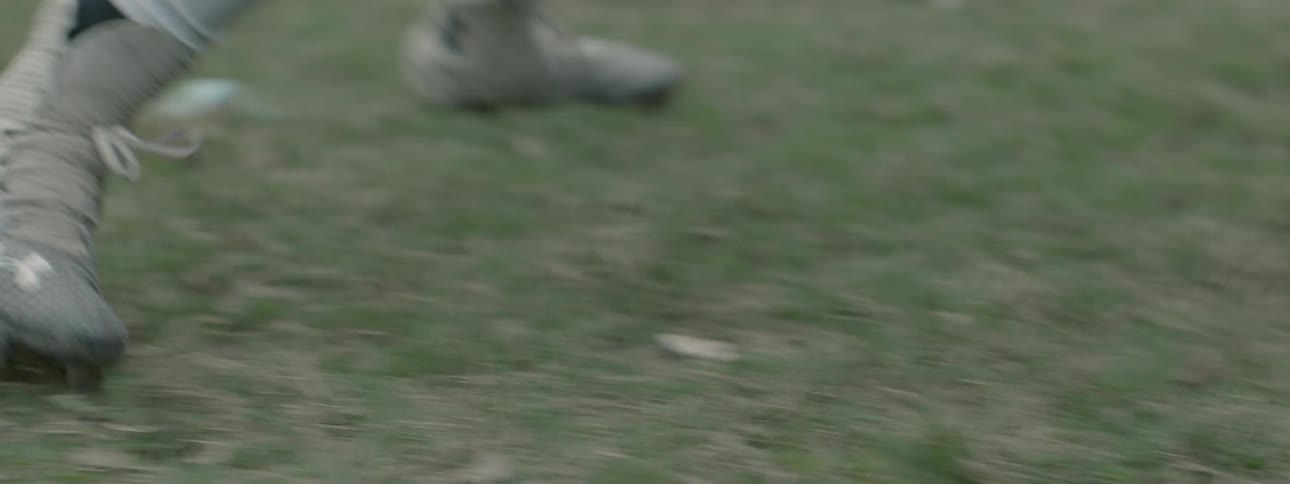 A person runs backwards in the grass