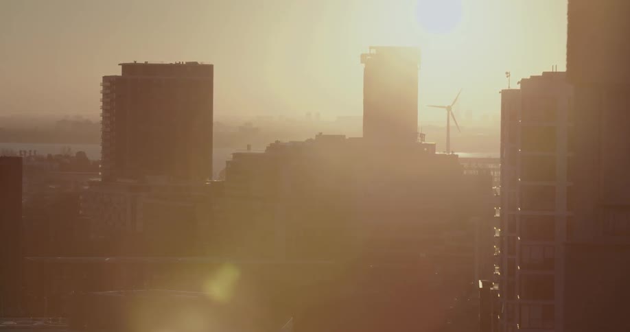 A city windmill spins on a sunny day