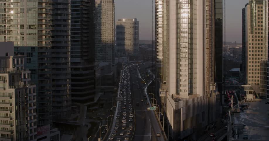 A crowded highway in between many skyscrapers