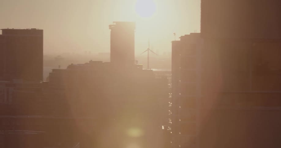 A city windmill spins on a sunny day
