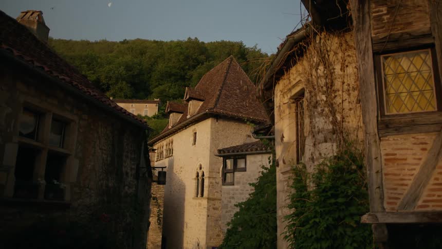 A village with old stone houses featuring intricate details like weathered roofs and medieval architecture