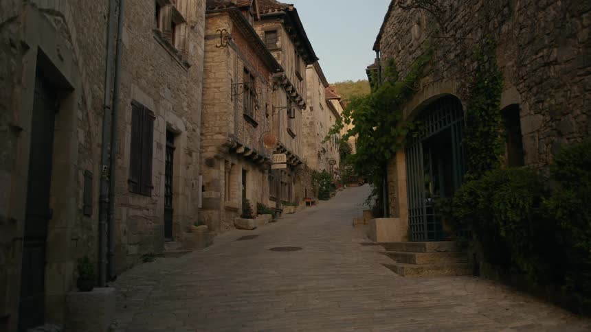 Walking down a stone street lined with old buildings