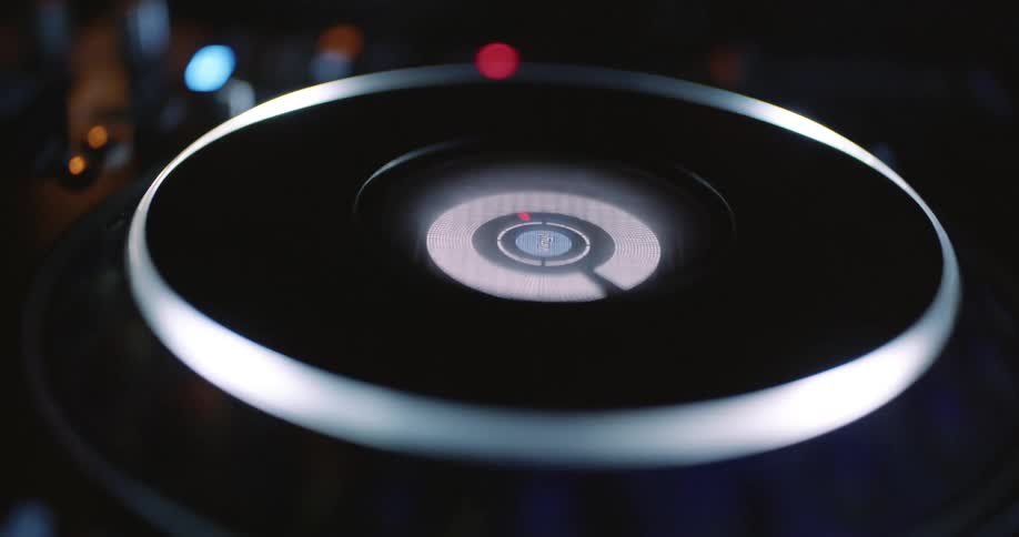 Closeup of a dj turntable illuminated by soft lights