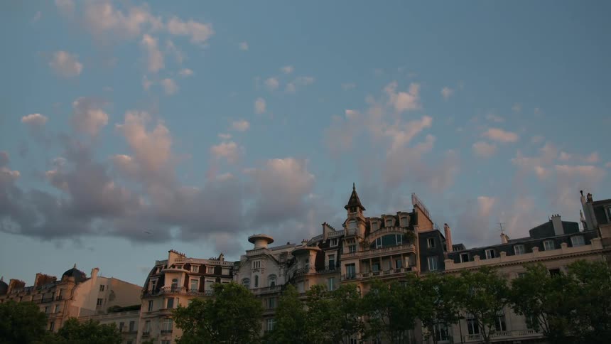 Historic buildings with classical architecture stand out against a blue sky