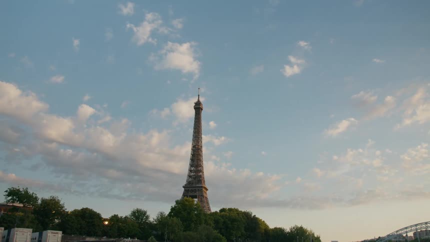A distant view of the eiffel tower on a partly cloudy day