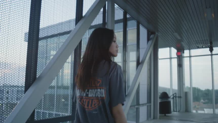 A woman walks down the hall and turns around
