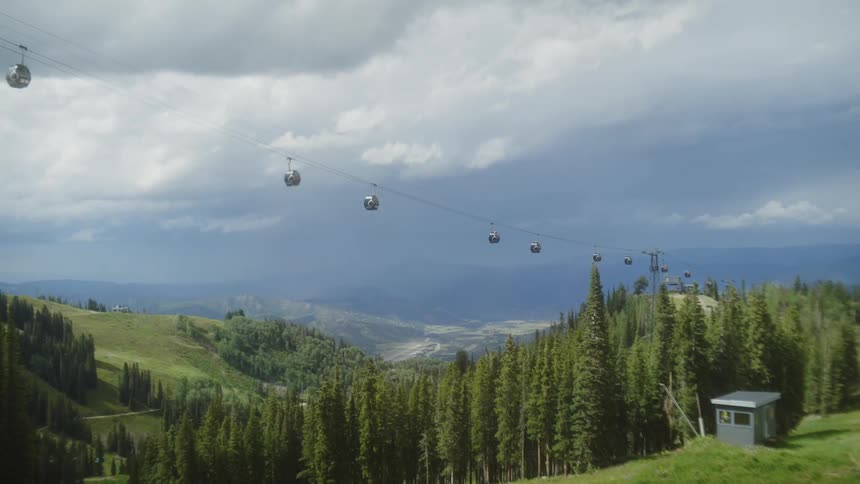A ski lift is running over the forest