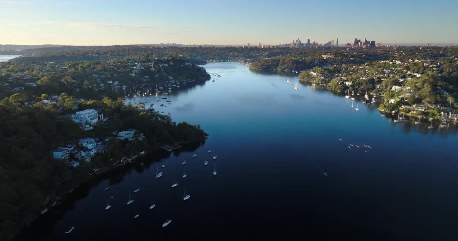 Aerial view of a sea canal surrounded by an urban city with boats
