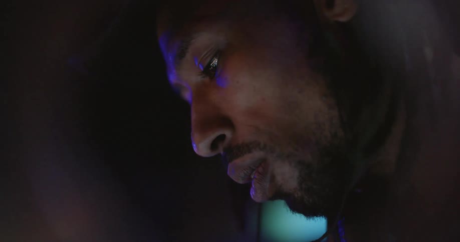 A man is walking outside at night